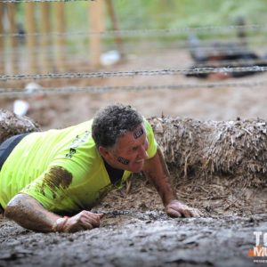 TJC Tough Mudder 2018 Brian crawling in mud